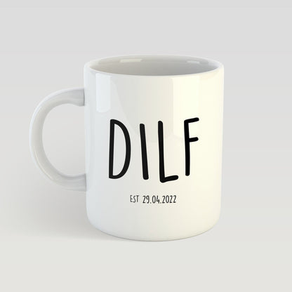 White mug with 'DILF' printed on it against a light gray background