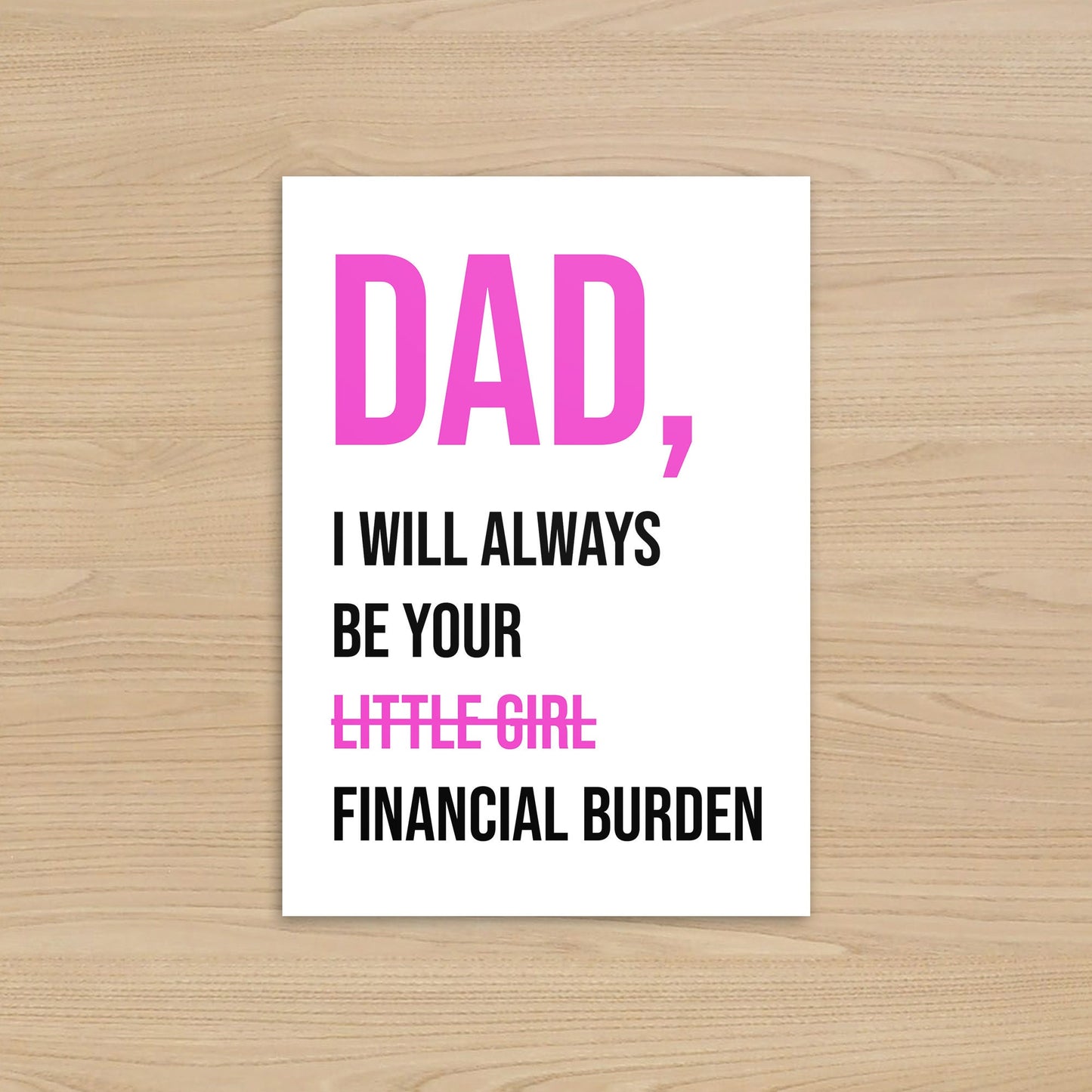 Card with humorous text on a wooden surface